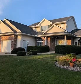 Central Minnesota farmhouse with new roof installed by Midsota Roofing LLC